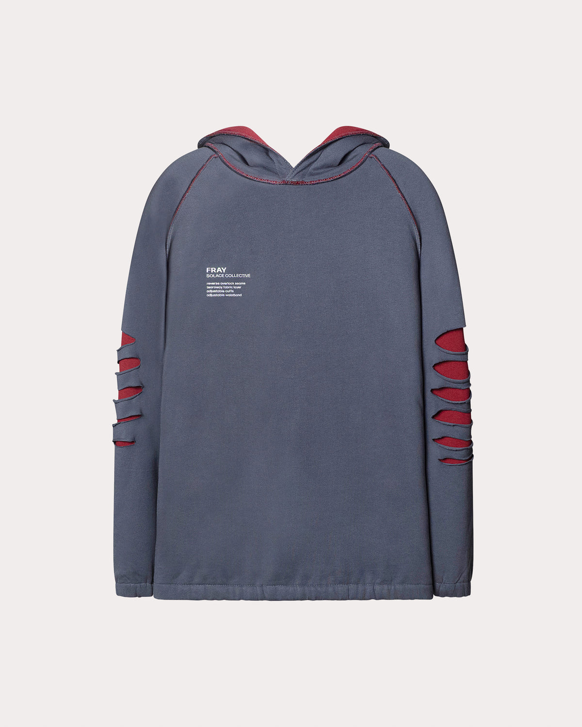 The image shows the FRAY hoodie in blue from SOLACE Collective laid flat, featuring raglan sleeves, contrast red interior lining, and the signature slashed arm panels that expose the underlying fabric. The front graphic sits on the left chest, and the overall silhouette appears relaxed and straight through the body.
This design features a tearaway fabric layer for tactile play and grounding comfort, a thick adjustable waistband with removable elastic for a customizable fit, and double-colored pockets.